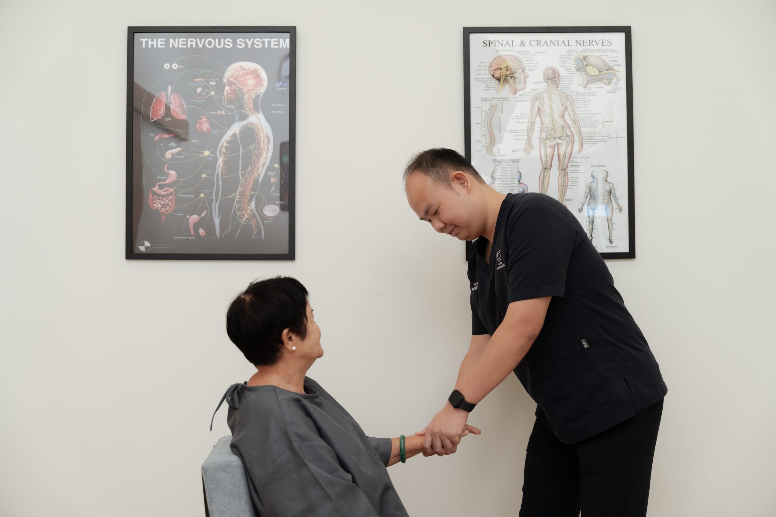 Rong Han is performing a wrist chiropractic adjustment