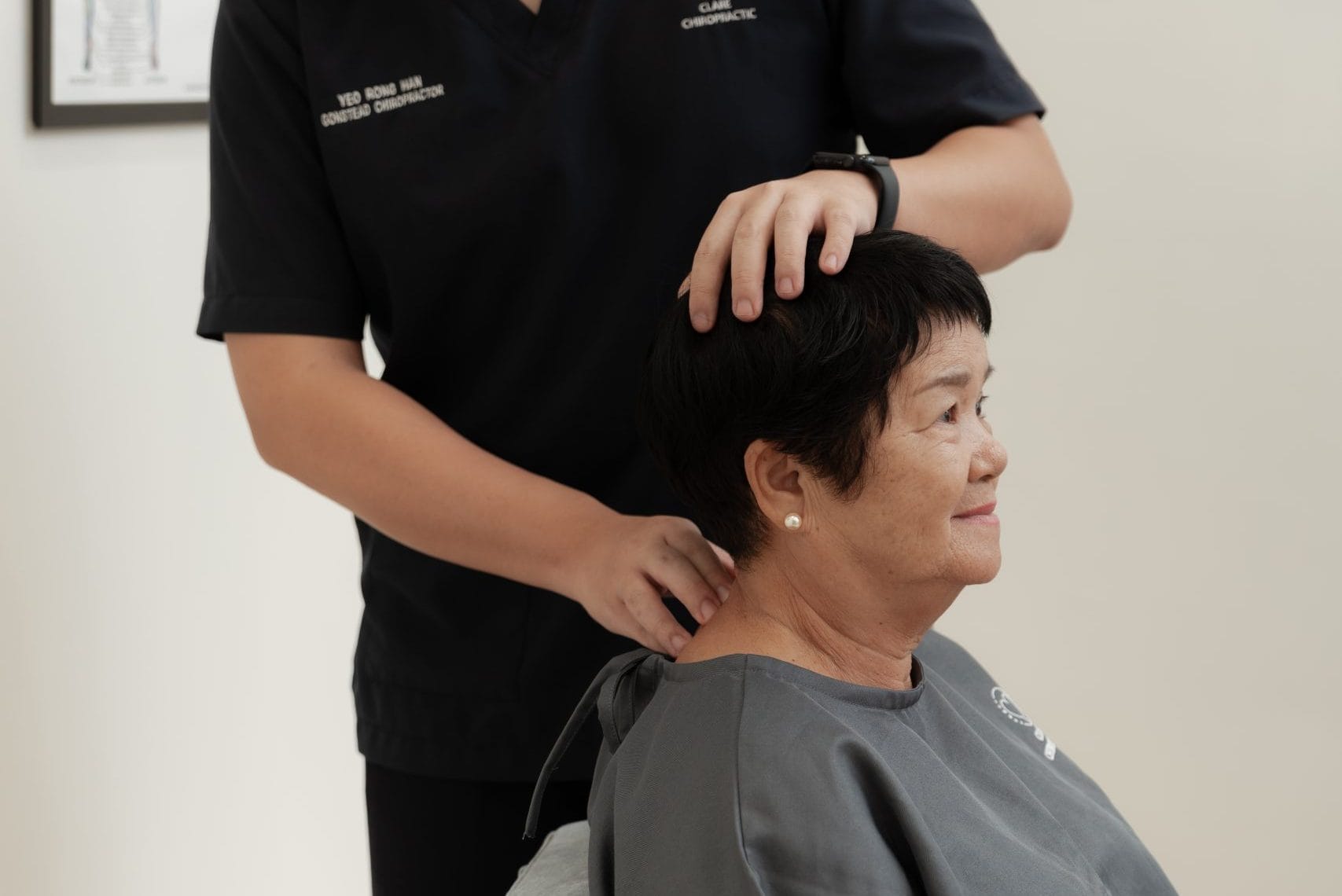 Rong Han is doing a neck motion palpation on a patient