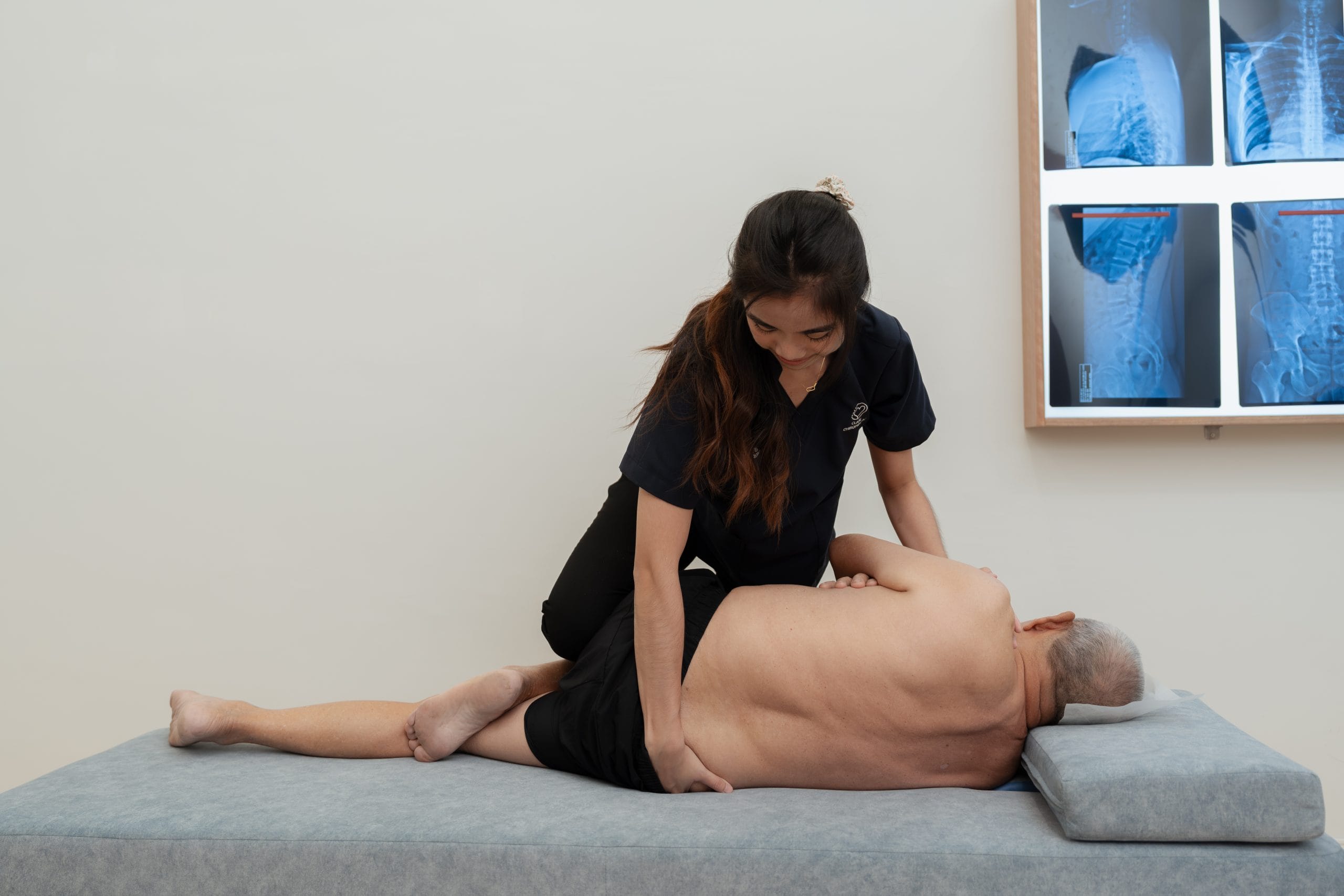 Pei Yun is doing a Pelvic Pull Adjustment on Pelvic Bench table