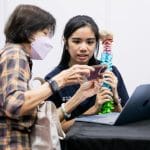 Pei Yun listening to a patient to share about her previous case injury