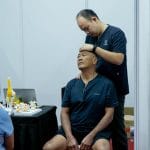 yeo performing motion palpation on a mister neck